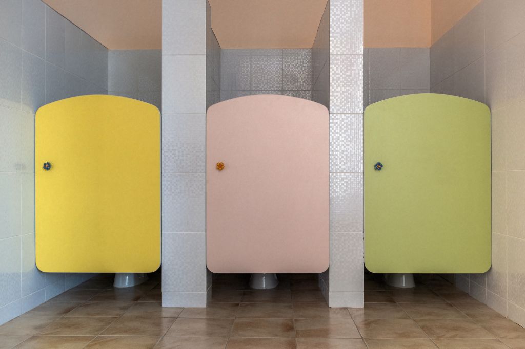 yellow, pink, and green bathroom stall doors